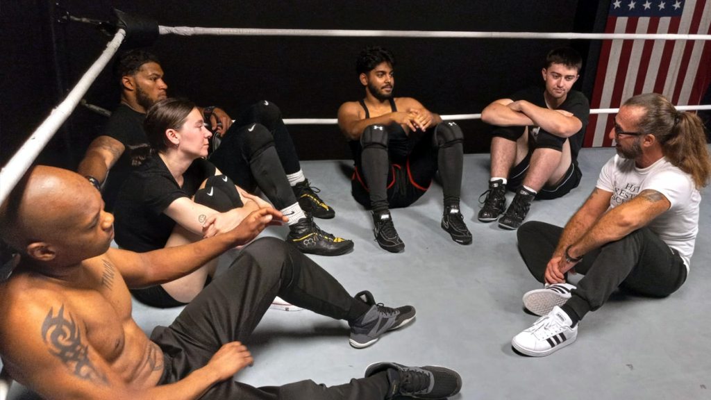 Head trainer Truth Martini speaks with his students at House of Truth Pro Wrestling School