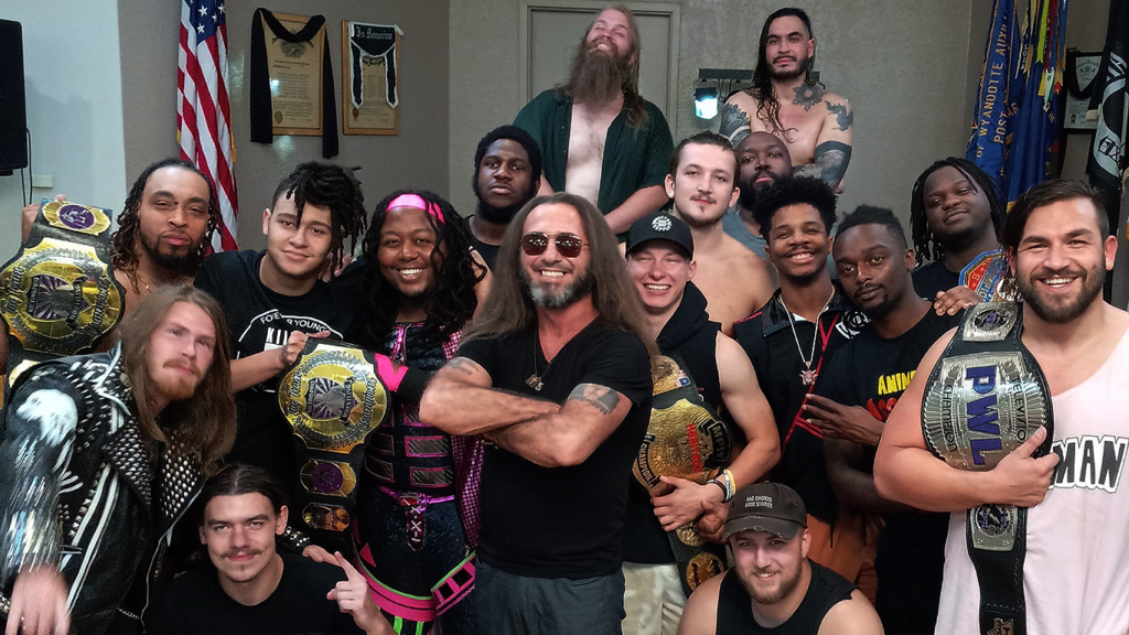 Truth Martini with graduates of the House of Truth Pro Wrestling School at a local show